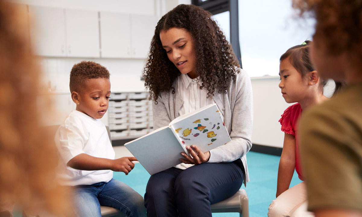 This is a photo of a teacher reading to students.